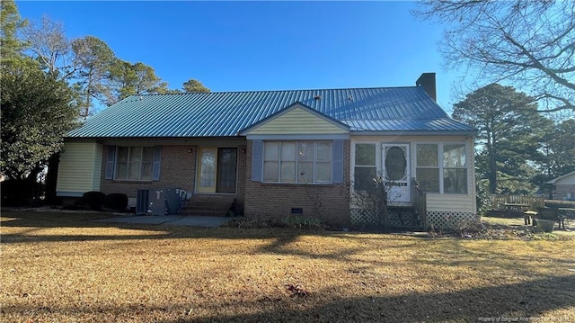 107 Oakmont Dr, Clinton, NC 28328 - view of front facade with metal roof, entry steps, a front yard, brick siding, and a chimney