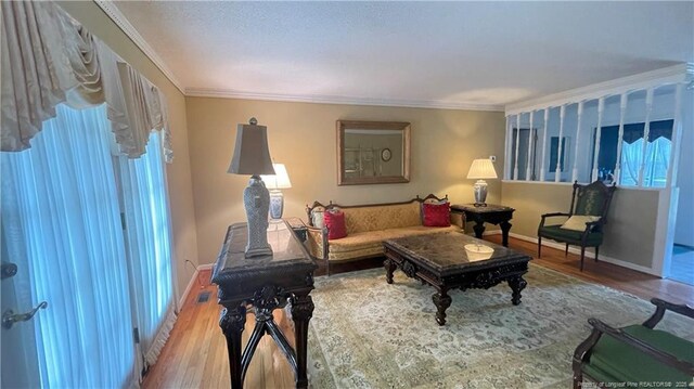 107 Oakmont Dr, Clinton, NC 28328 - living area with baseboards, crown molding, and wood finished floors