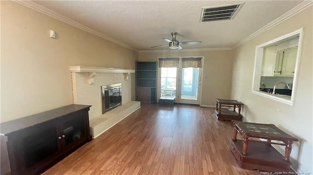107 Oakmont Dr, Clinton, NC 28328 - living room with a textured ceiling, visible vents, ceiling fan, ornamental molding, and wood finished floors
