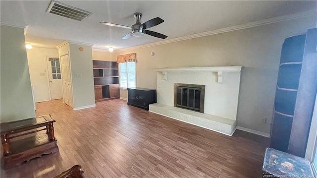 107 Oakmont Dr, Clinton, NC 28328 - unfurnished living room with visible vents, baseboards, ornamental molding, wood finished floors, and a ceiling fan