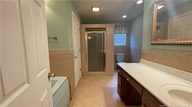 107 Oakmont Dr, Clinton, NC 28328 - full bath featuring tile walls, a textured ceiling, a shower stall, tile patterned floors, and vanity