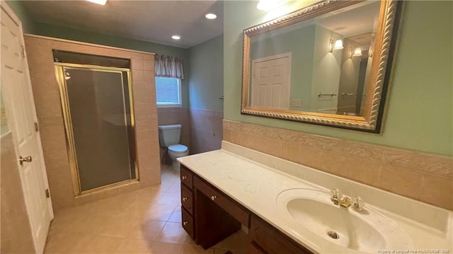 107 Oakmont Dr, Clinton, NC 28328 - bathroom with vanity, tile walls, toilet, a shower stall, and tile patterned floors