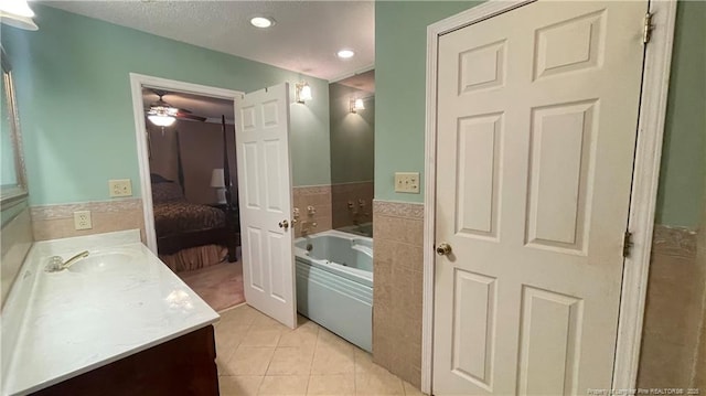 107 Oakmont Dr, Clinton, NC 28328 - ensuite bathroom with ceiling fan, tile patterned floors, vanity, ensuite bath, and a garden tub