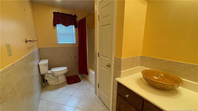 107 Oakmont Dr, Clinton, NC 28328 - full bath with vanity, tile walls, toilet, a wainscoted wall, and tile patterned floors