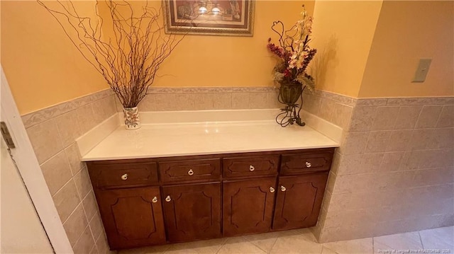 107 Oakmont Dr, Clinton, NC 28328 - bathroom featuring tile walls, tile patterned flooring, and wainscoting