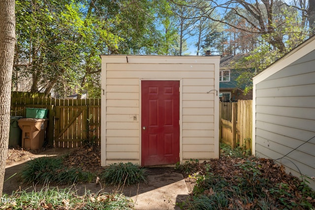 view of shed featuring fence