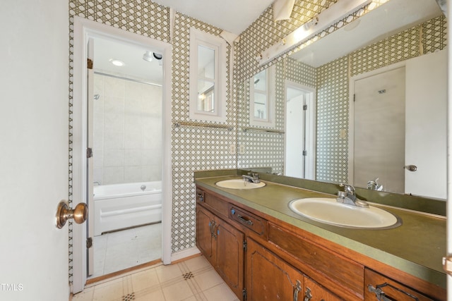 full bathroom with double vanity, a sink, and wallpapered walls