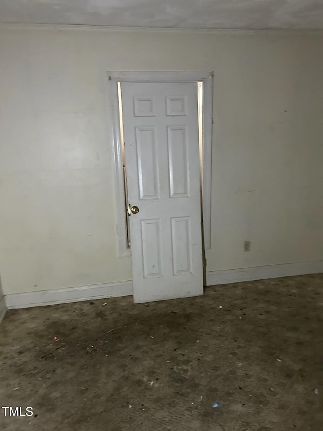 spare room with baseboards