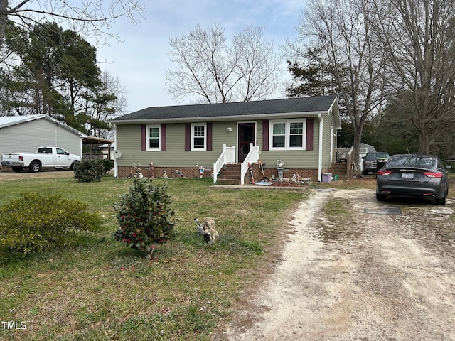 view of front of house featuring driveway, crawl space, and a front yard