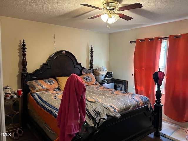 bedroom with ceiling fan and a textured ceiling