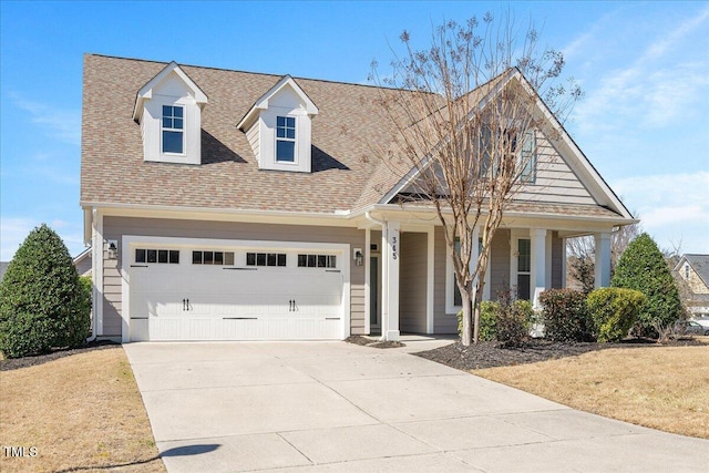 view of front of house with covered porch, driveway, and roof with shingles