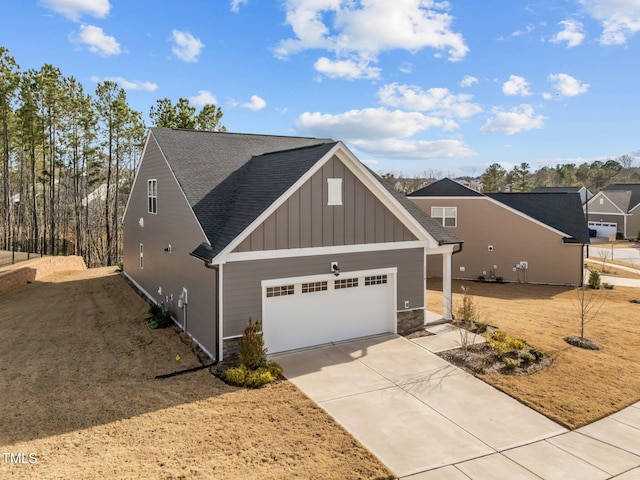 exterior space with driveway, an attached garage, a shingled roof, stone siding, and board and batten siding