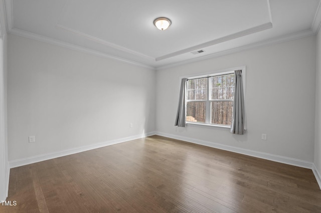 unfurnished room featuring dark wood finished floors, crown molding, baseboards, and visible vents