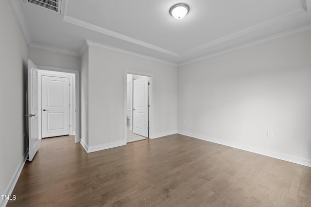 unfurnished bedroom featuring visible vents, crown molding, dark wood-type flooring, and baseboards