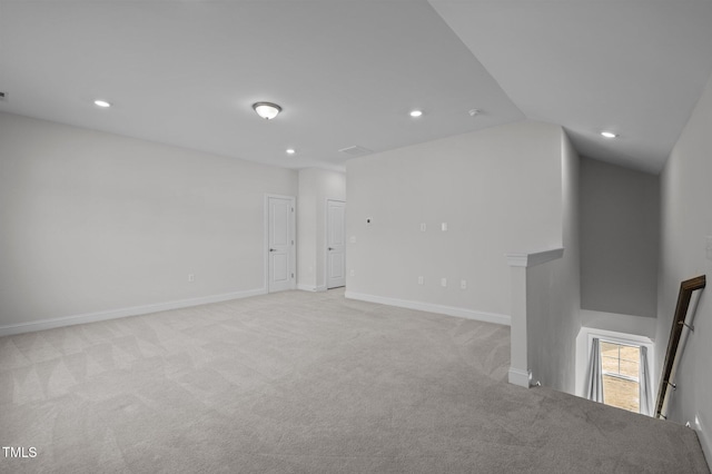 unfurnished room with recessed lighting, baseboards, light colored carpet, and vaulted ceiling