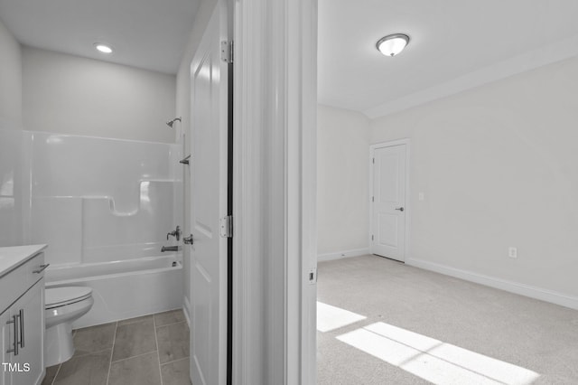 bathroom with toilet, vanity, shower / bath combination, and baseboards