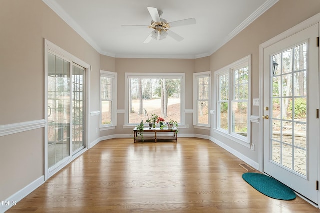 unfurnished sunroom with visible vents and ceiling fan