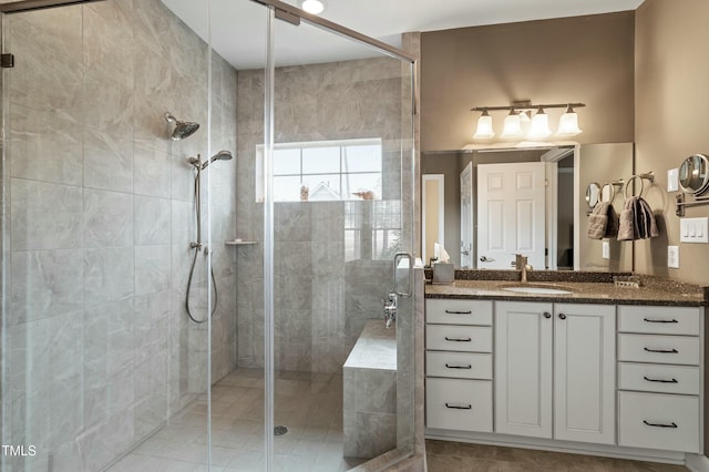 bathroom with a stall shower and vanity