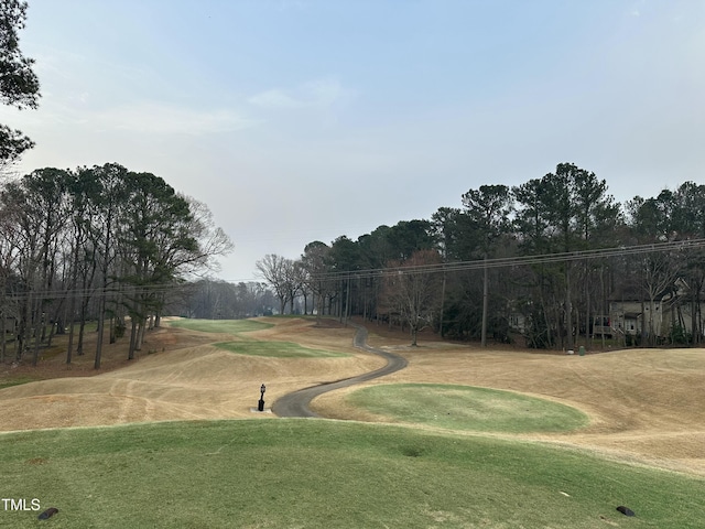 view of community featuring a lawn and golf course view