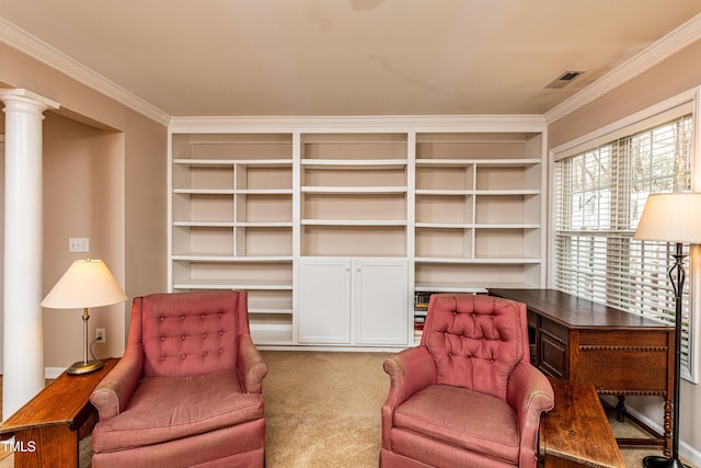 sitting room featuring visible vents, ornamental molding, carpet floors, ornate columns, and built in shelves