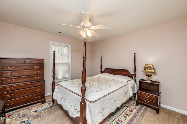 bedroom featuring light carpet, ceiling fan, visible vents, and baseboards