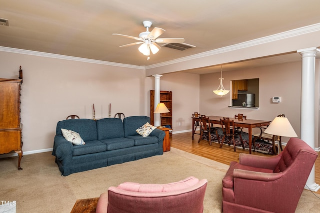 living room featuring visible vents, ornamental molding, decorative columns, and a ceiling fan