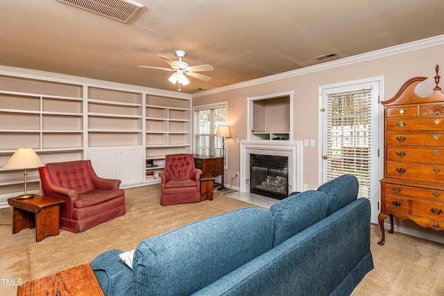 carpeted living area featuring crown molding, visible vents, and a healthy amount of sunlight