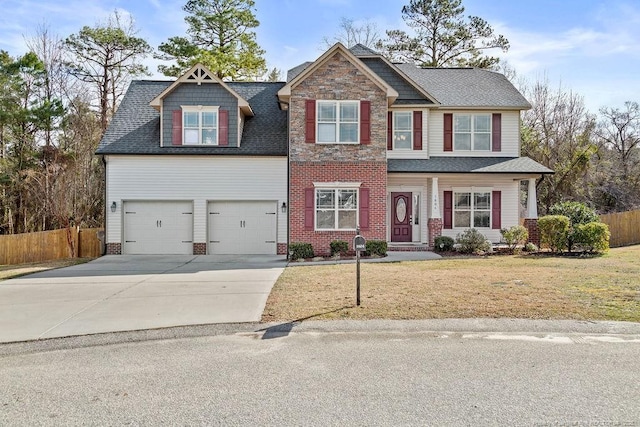 craftsman inspired home featuring a garage, brick siding, fence, concrete driveway, and a front yard