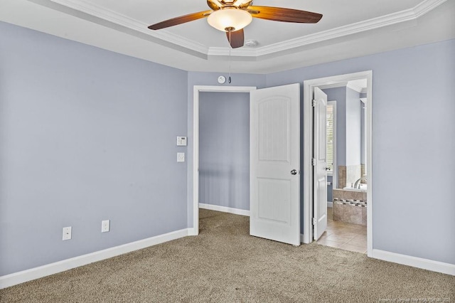 unfurnished bedroom with ornamental molding, a raised ceiling, light carpet, and baseboards