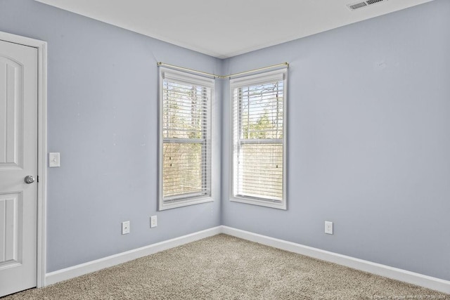 unfurnished room featuring carpet flooring and baseboards