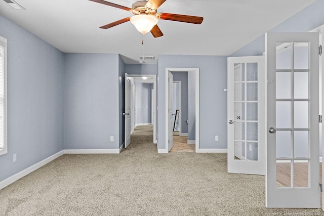 unfurnished bedroom with carpet, visible vents, baseboards, and french doors