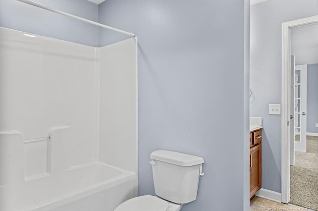 bathroom with toilet, shower / bathtub combination, baseboards, and vanity