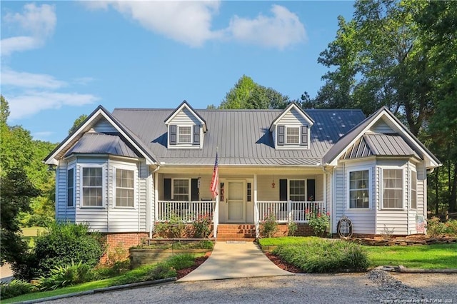 cape cod house featuring a porch