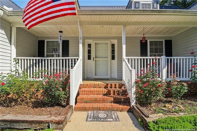 view of exterior entry with covered porch