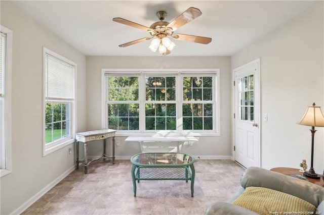 interior space featuring ceiling fan and baseboards