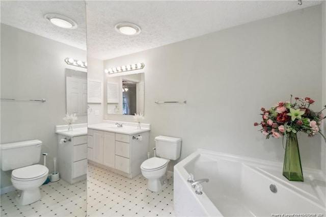 full bathroom featuring toilet, a garden tub, a textured ceiling, and vanity