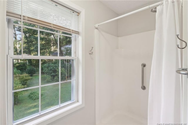 full bath with a healthy amount of sunlight and a shower stall