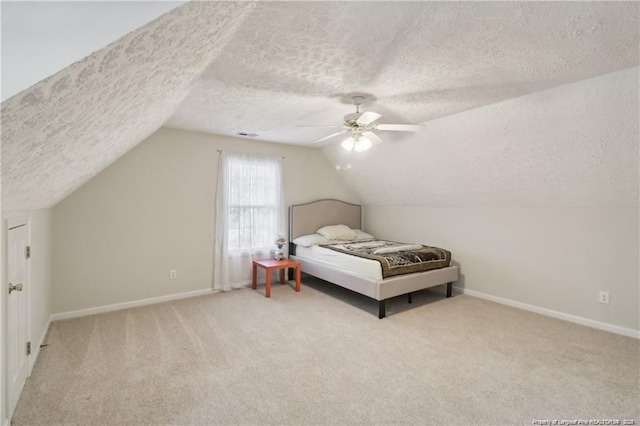 bedroom with lofted ceiling, carpet flooring, a ceiling fan, and baseboards