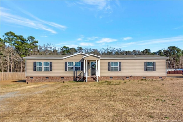 manufactured / mobile home with crawl space, a front yard, and fence