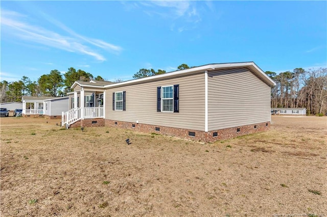 exterior space featuring crawl space and a yard