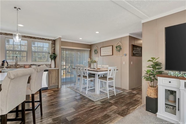 dining area featuring dark wood-type flooring and ornamental molding