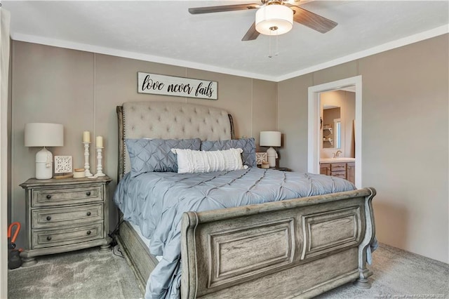 bedroom with a ceiling fan, ensuite bath, crown molding, carpet flooring, and a sink