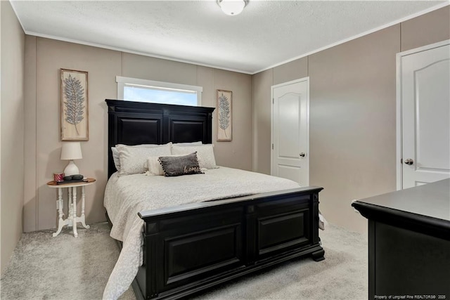 bedroom featuring light carpet and a textured ceiling