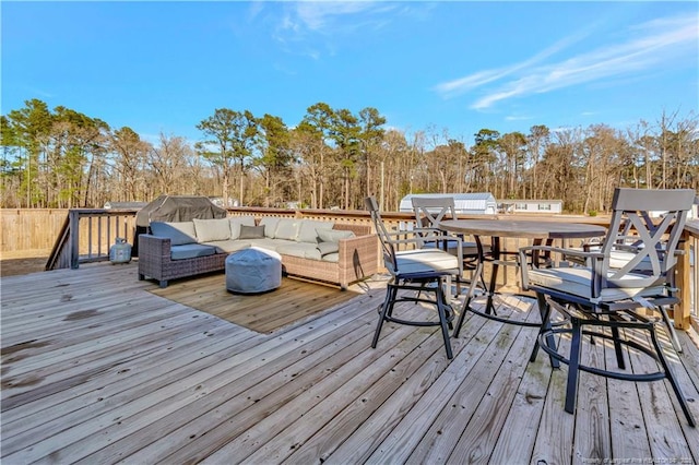 wooden terrace featuring an outdoor living space and outdoor dining space