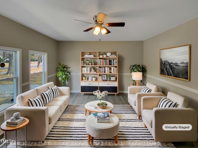 living area with ceiling fan, baseboards, and wood finished floors