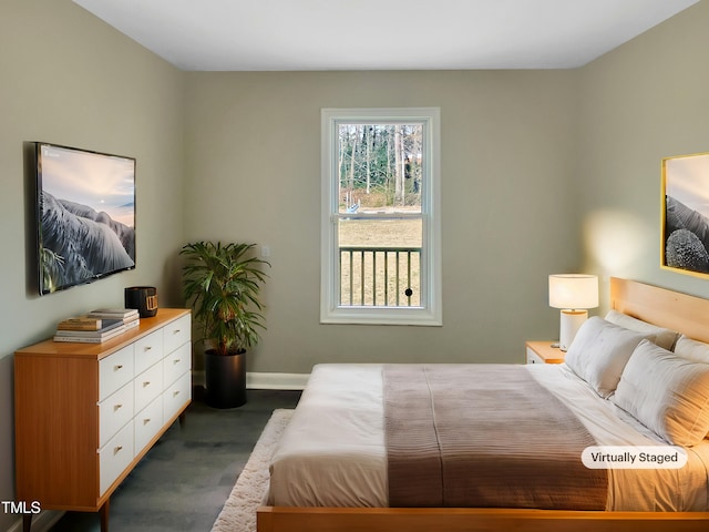 bedroom with baseboards and dark wood finished floors