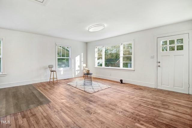 unfurnished room with baseboards and wood finished floors