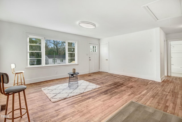 foyer featuring visible vents, baseboards, and wood finished floors