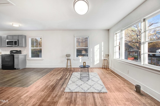 sitting room featuring baseboards and wood finished floors