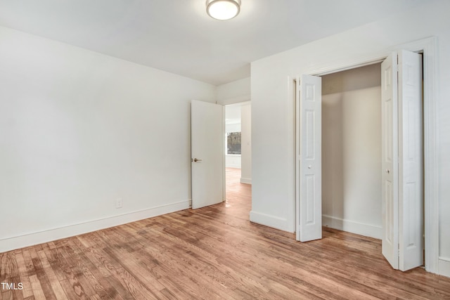 unfurnished bedroom featuring baseboards and wood finished floors